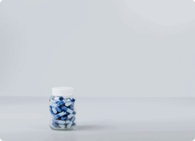 Blue pills in a glass bottle