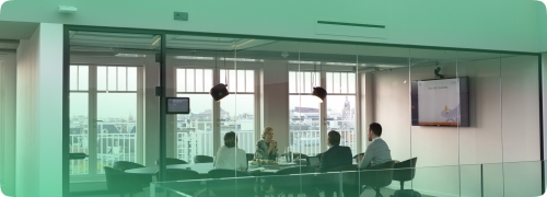 Four people in a meeting room