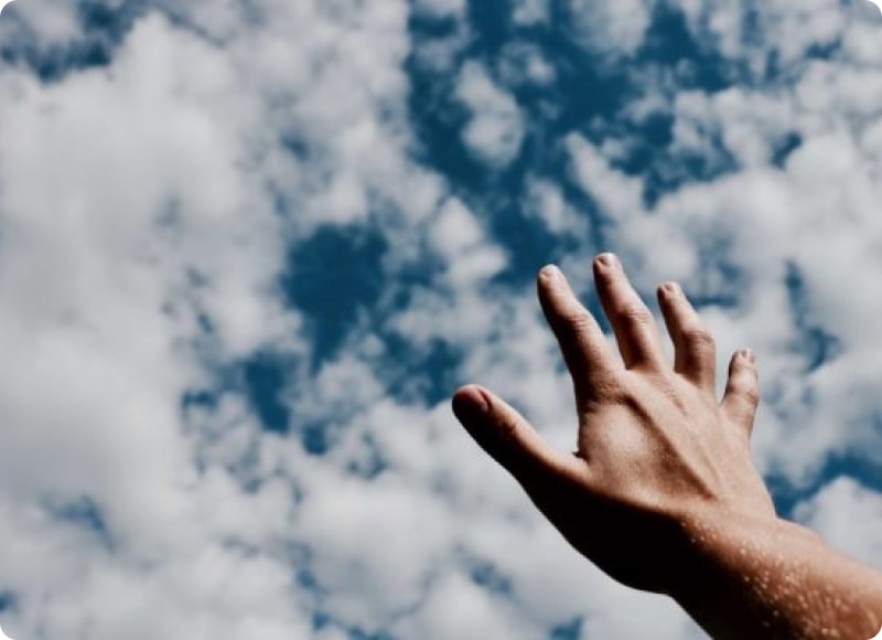 Cloudy sky and hand