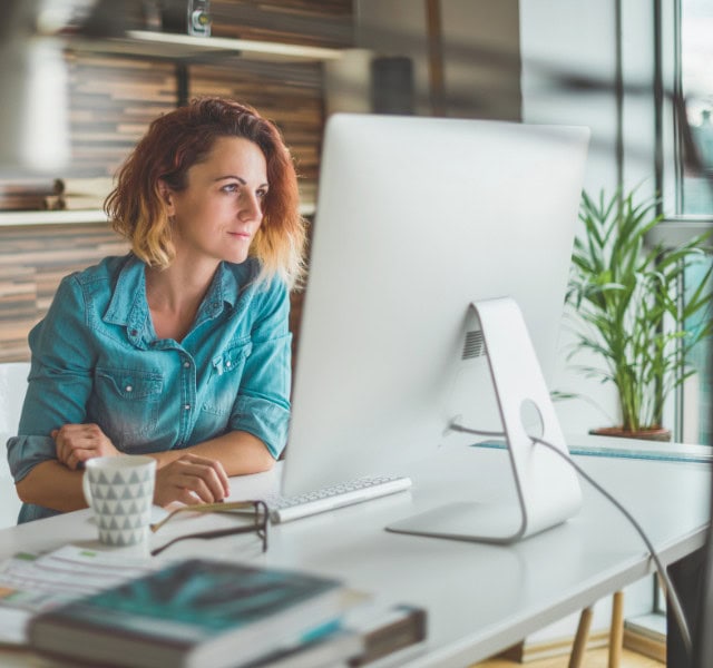 software engineer, woman - sitting in front of the monitor and working